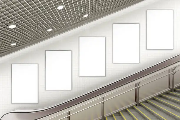 Five blank vertical advertising posters on wall of underground escalator. 3d illustration