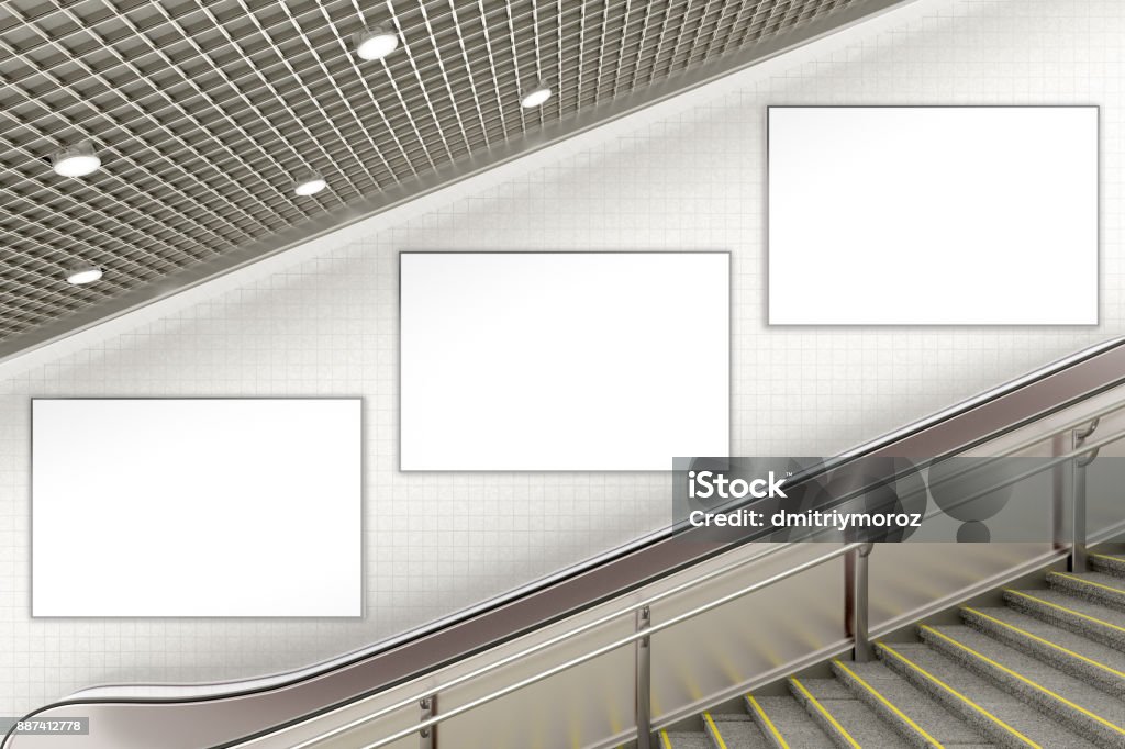 Blank advertising poster on underground escalator wall Three blank advertising posters on underground escalator wall. 3d illustration Billboard Stock Photo