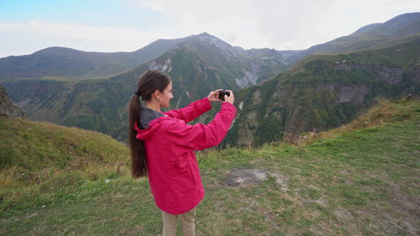 istock A Young Lady Taking Photos in the Mountains 887423924
