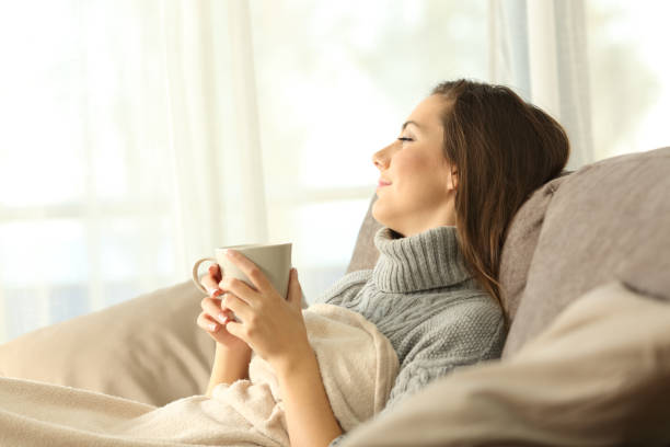 istock Pensive woman relaxing at home in winter 887424372