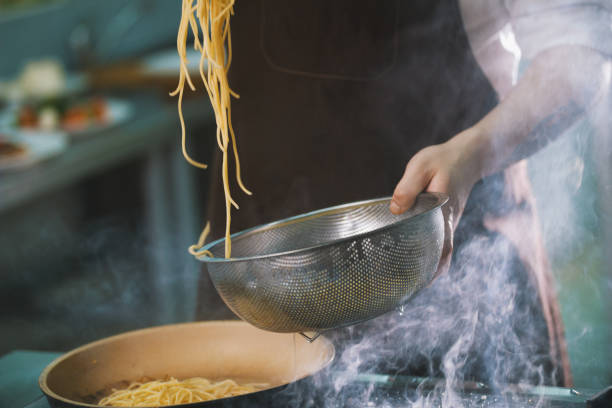 istock Process of cooking spaghetti in restaurant 887424760