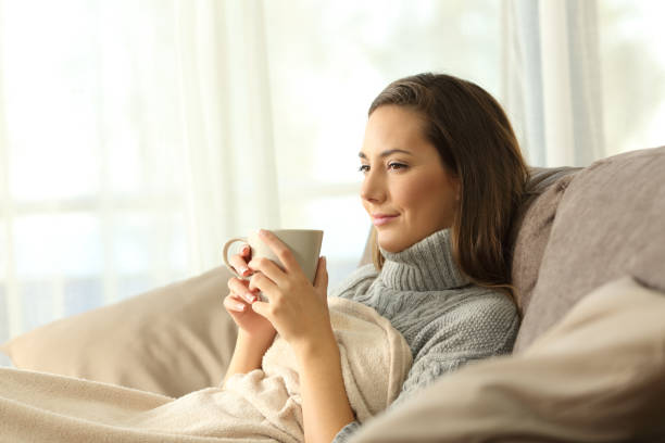 istock Tenant resting holding coffee on a couch 887427260
