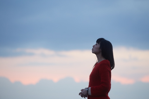 woman and the sunset clouds