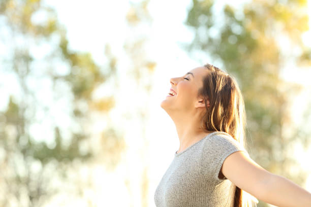 istock Woman breathing fresh air outdoors in summer 887436646
