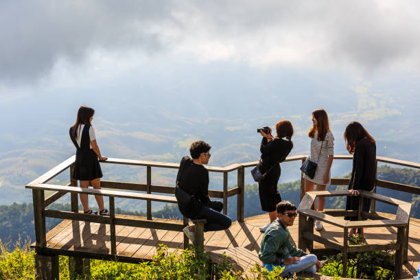 CHIANG MAI, THAILAND - 06 NOVEMBER 2016 - Unidentified tourists enjoy taking their portrait photograph with nature background at Kew Mae Pan panoramic vantage point.
