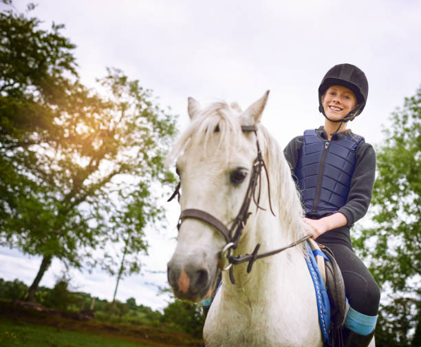Shot of a teenage girl going horseback riding on a ranch