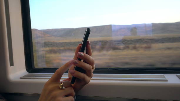 istock A Young Lady's Hands Using a Smartphone in the Train 887441870