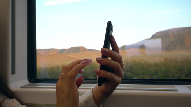 istock A Young Lady's Hands Using a Smartphone in the Train 887442042