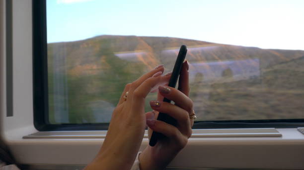 istock A Young Lady's Hands Using a Smartphone in the Train 887442122