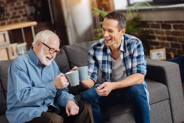 istock Pleasant young man drinking tea with his elderly father 887442334