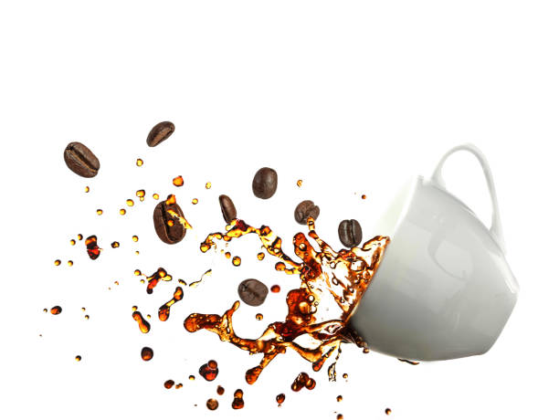 istock Coffee splashing from a cup together with coffee beans isolated on white background with clipping path 887442384