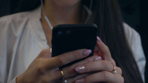 istock A Young Lady's Hands Using a Smartphone in the Train 887442508