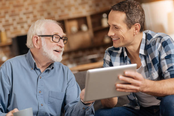 istock Cheerful father and son discussing recent news 887446840
