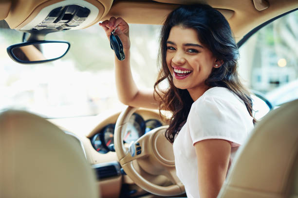 I'll be on the move anytime now Shot of an attractive young woman excited about her new car car ownership photos stock pictures, royalty-free photos & images