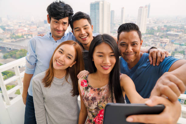 istock Group of friends taking a selfie together 887448194