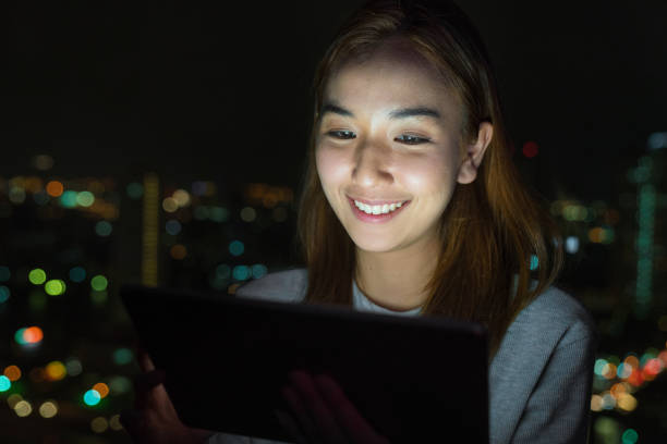 istock Young woman working late 887448380