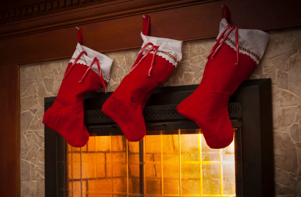 istock Three stockings on the fireplace 887452550