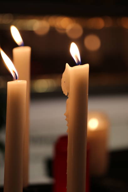 istock Close-Up Of Illuminated Candles 887453122