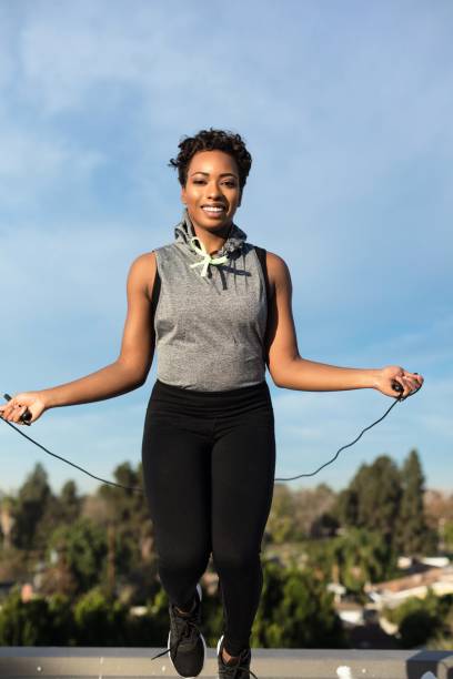 istock Young woman working out on rooftop in suburbs 887463806