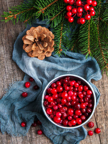 istock Red cranberries on a old wooden table 887464182