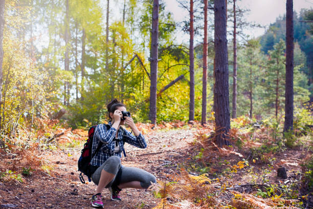 istock Young Woman with retro photo camera 887470862