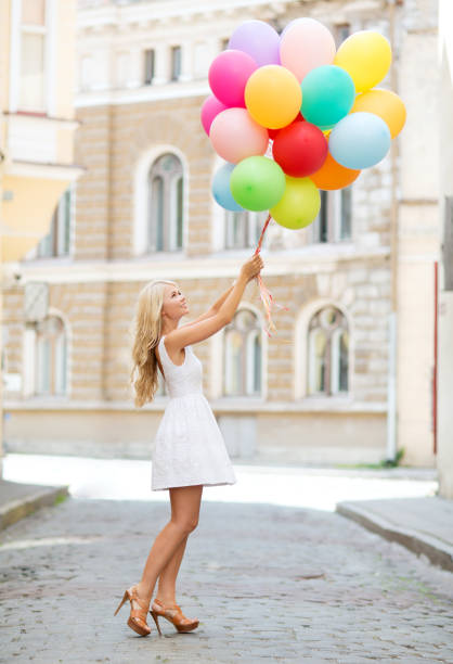istock woman with colorful balloons 887470940