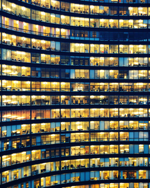 istock Office workers working late in major office building 887479894