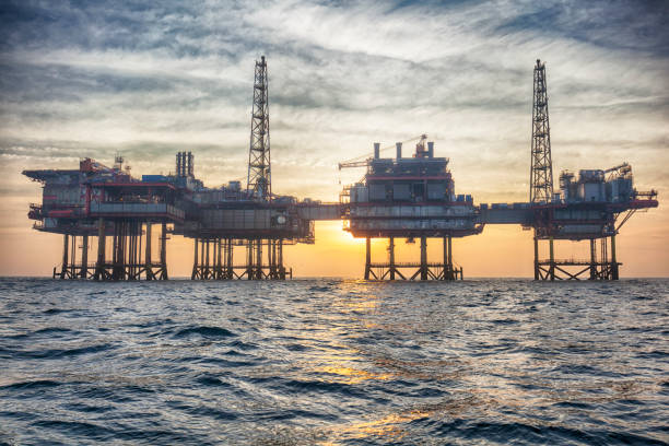 HDR offshore oil platform at sunset stock photo