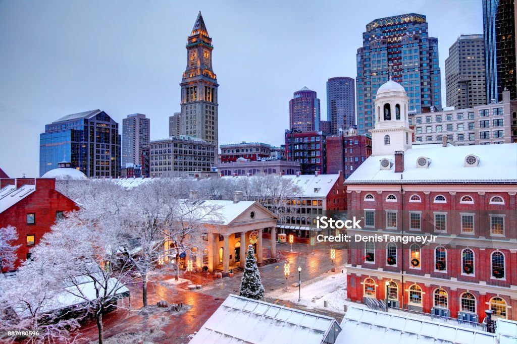 Winter in Boston Faneuil Hall rooftops covered in snow during the winter season in Boston. Faneuil Hall Also known as Quincy Market is located near the waterfront and Government Center, in Boston, Massachusetts, has been a marketplace and a meeting hall since 1743.  Boston is the largest city in New England, the capital of the Commonwealth of Massachusetts Boston - Massachusetts Stock Photo