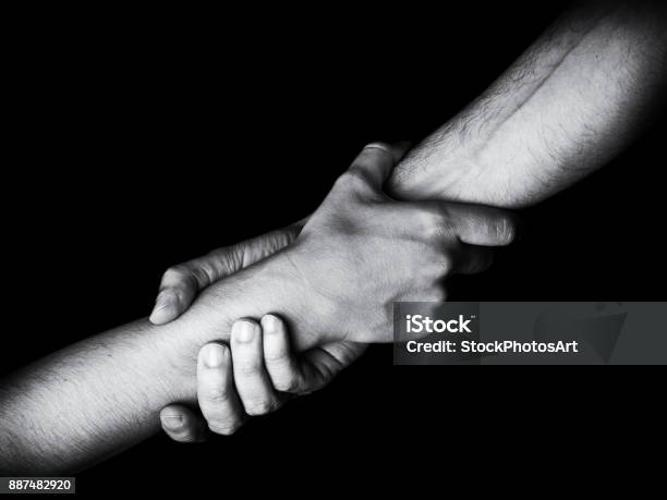 Man Saving Rescuing And Helping Woman By Holding Or Griping The Forearm Stock Photo - Download Image Now