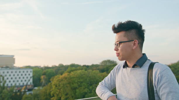 istock Young Man Drinking on the Terrace 887483114