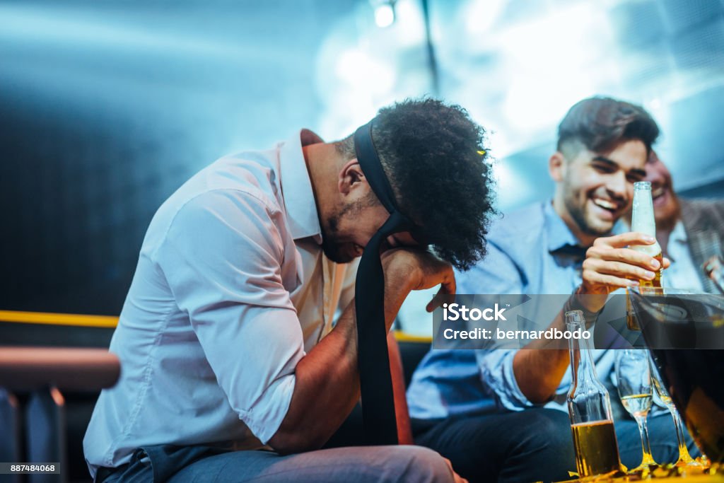 Too much alcohol Shot of a man laughing in the nightclub Stag Night Stock Photo