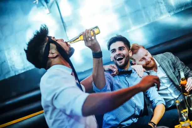 Group of young men having fun at a bar