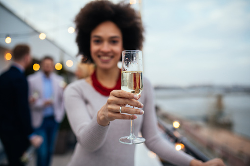 Shot of a young woman holding champagne flute
