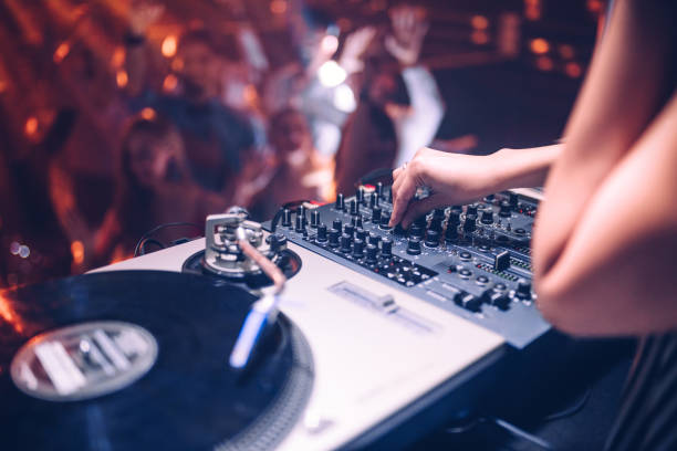 Put up the volume ! Cropped shot of a DJ playing music at the club dj stock pictures, royalty-free photos & images