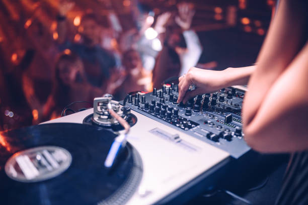 Put up the volume ! Cropped shot of a DJ playing music at the club club dj stock pictures, royalty-free photos & images