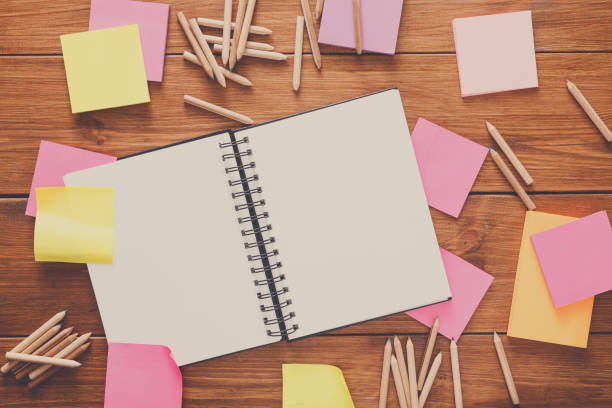 istock Top view of blank notepad on wooden office desk 887485176