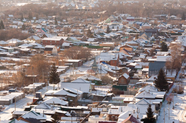 istock Rustic houses in winter, light smoke from the pipes. Top view with blur. 887491008