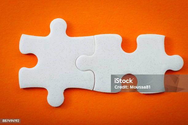 Business Concept Connected Puzzle Pieces On Orange Background With Copyspace Stock Photo - Download Image Now