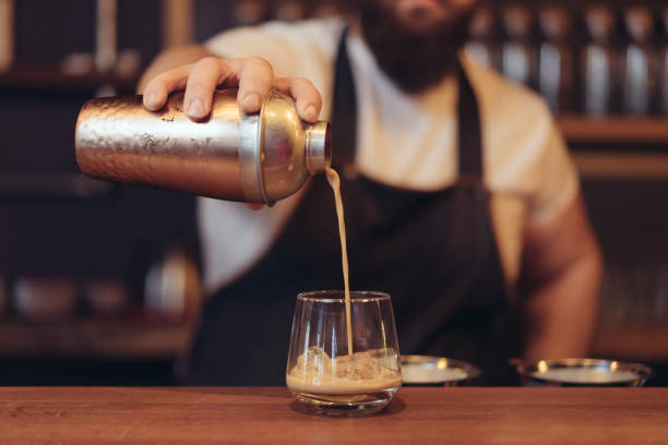 istock Man hand pouring milk in coffee 887494658