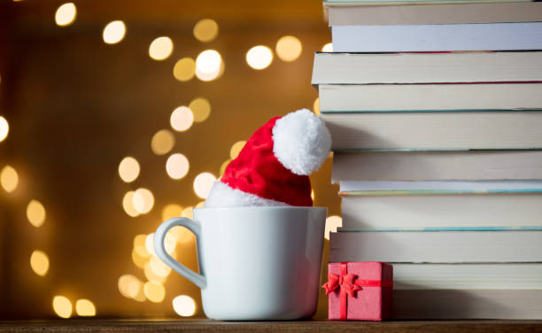 istock white cup with Christmas hat and books 887494798