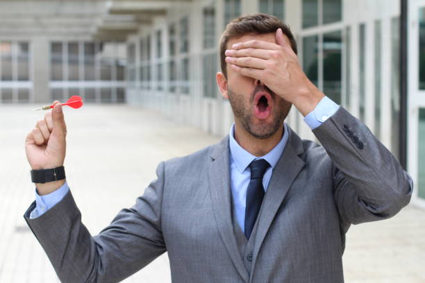 istock Blind businessman holding a dart 887495410