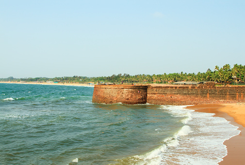 Goa, India - February 26, 2015: Taj Aguada fort near Sinquerium beach at sunny day