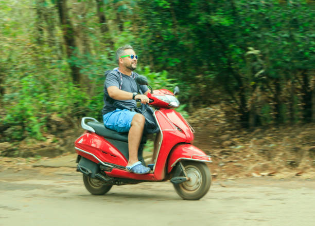istock Happy young man drives a red motorcycle 887522824