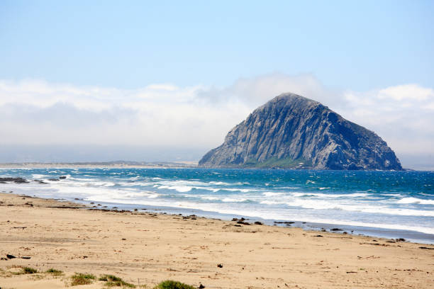 Morro Rock is a volcanic plug in Morro Bay, California, on the Pacific Coast at the entrance to Morro Bay harbor.