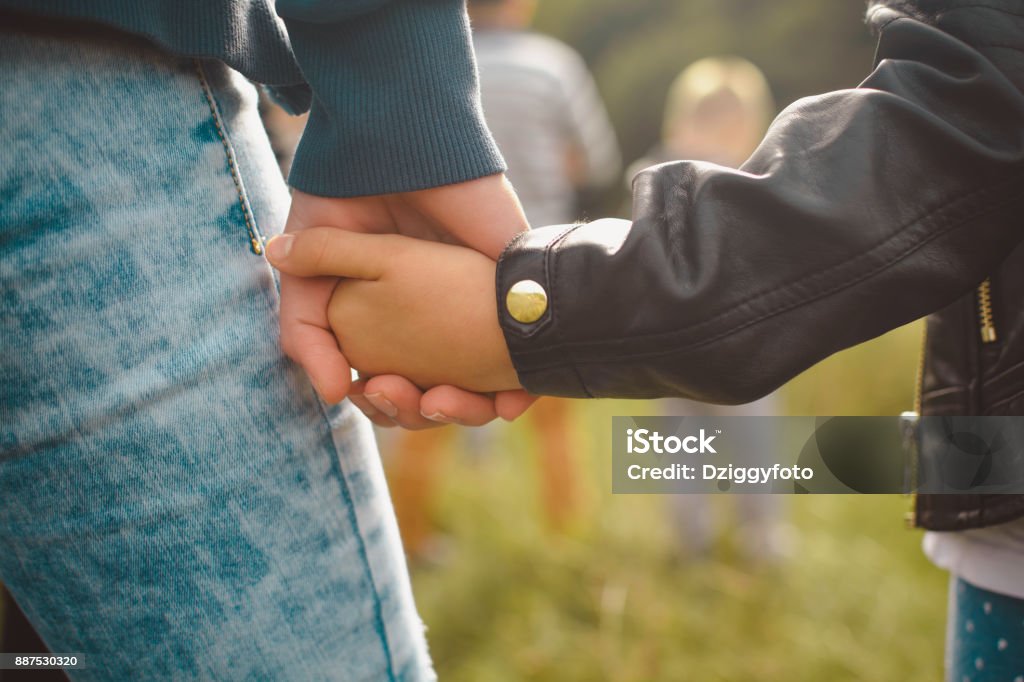 Holding tight Close up of mother holding daughter's hand Holding Hands Stock Photo