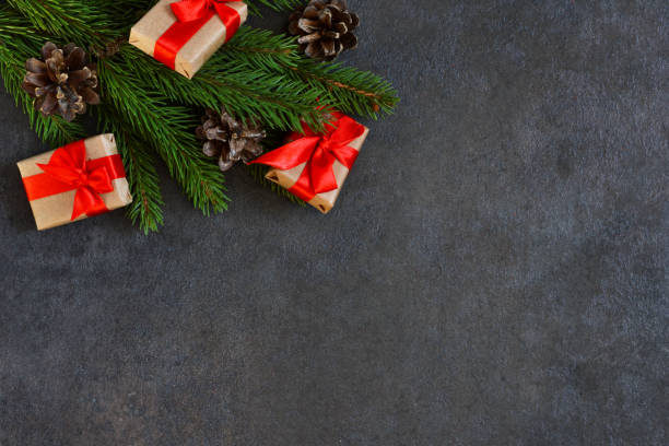 istock Christmas card with decorations from a Christmas tree with gifts on a black background. 887532286
