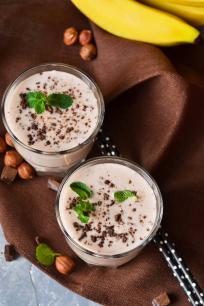 istock Vanilla, Banana smoothie with cookies and chocolate on a concrete background 887533270