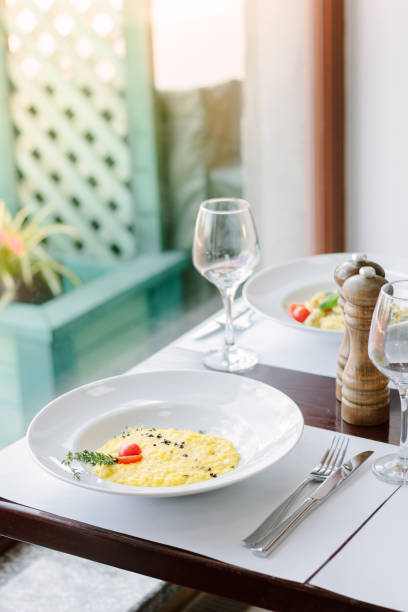 istock Risotto on a table at traditional italian restaurant. 887554522