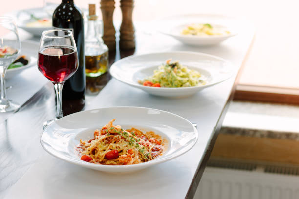 Table at italian restaurant served with traditional spaghetti pasta